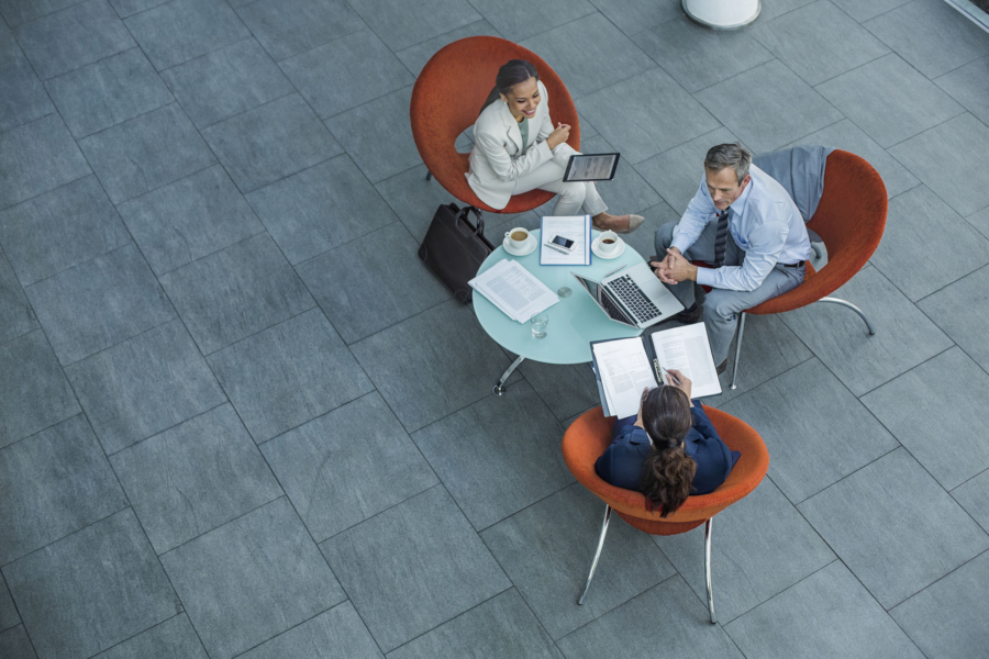 A team working around a table, to signify human centricity in the workplace