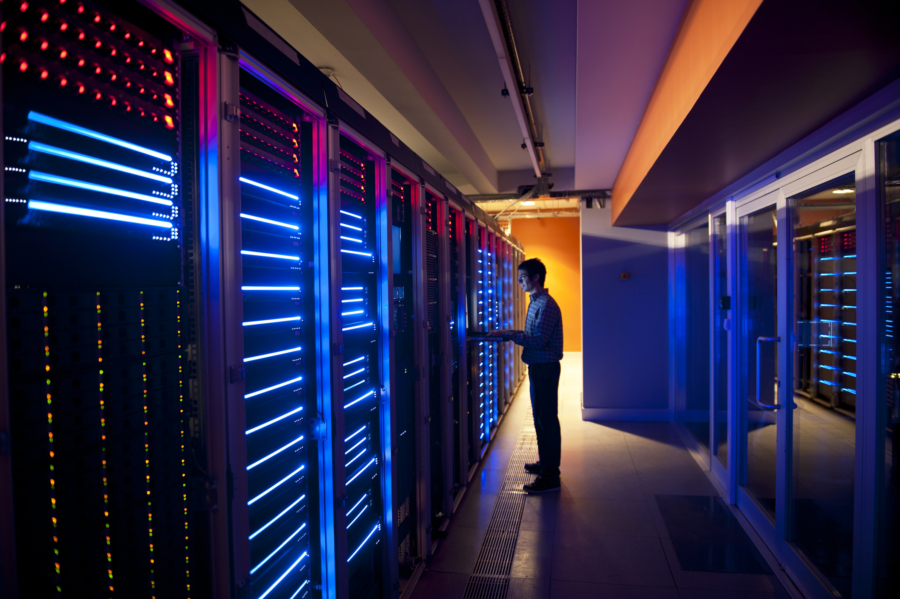 Man in server room to signify artificial intelligence and machine learning