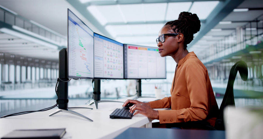 A woman looking at her computer to signify the different software programs used any given day.