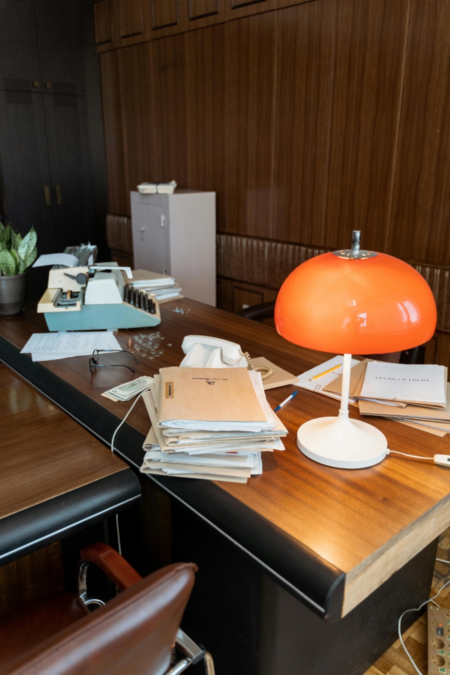 Disorganized desk, with a stack of files