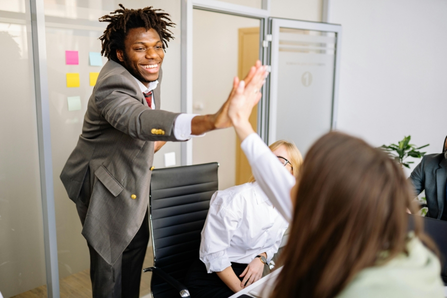 A high five to signify a successful CLM implementation project